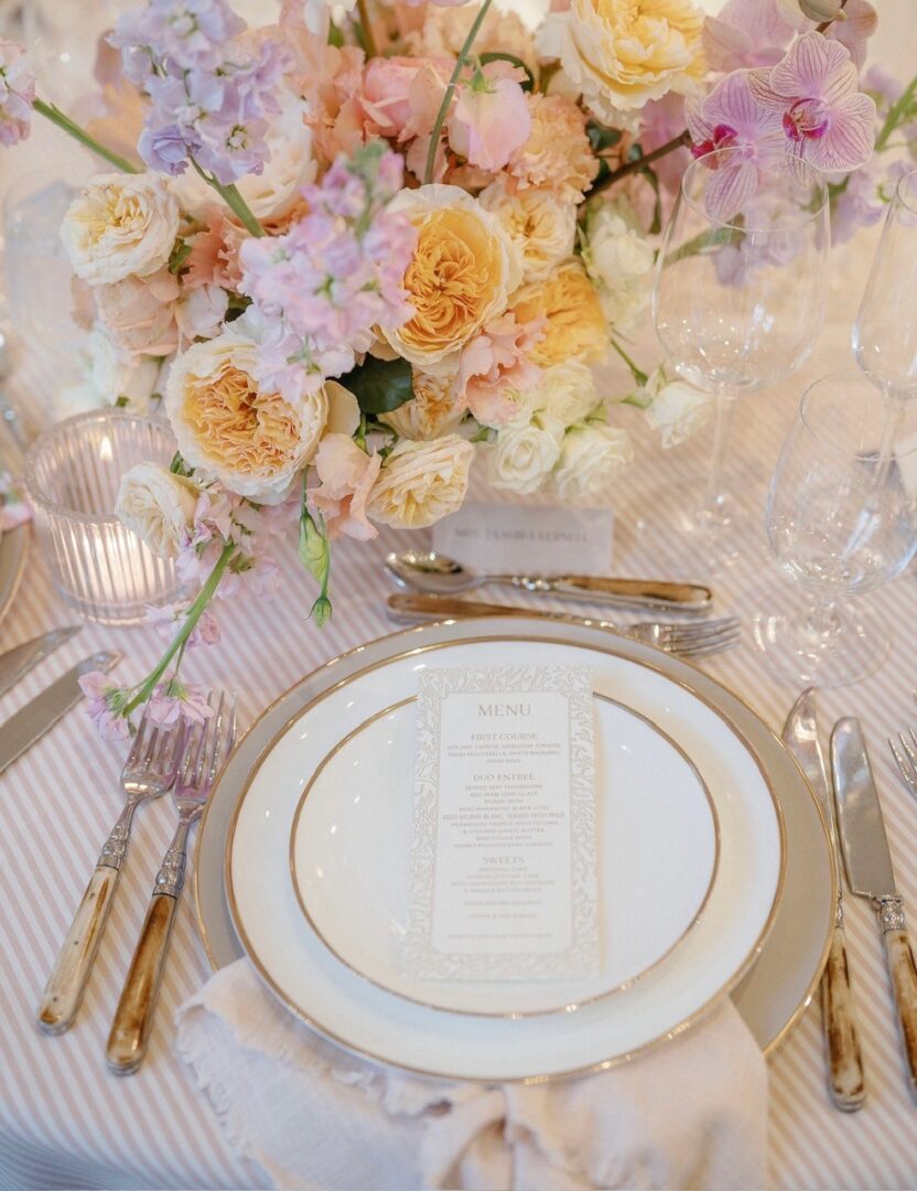 Elegant floral centerpiece with gold-rimmed place setting